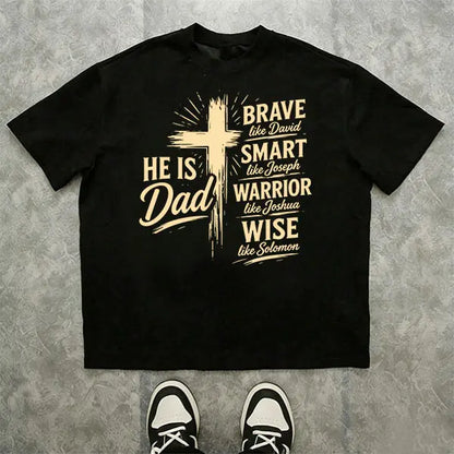 Men’s Christian “Dad” graphic T-shirt: “He Is Dad — Brave, Smart Warrior, Wise”; religious Father’s Day short-sleeve tee with cross print; casual inspirational top for everyday wear, church, and family events